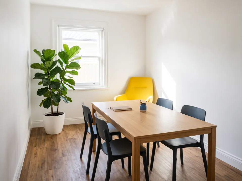 Light-filled office meeting space with yellow accents
